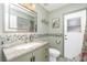 Bathroom featuring granite countertops, decorative wall tiles, and a well-lit mirror above the sink at 926 Boundary Blvd, Rotonda West, FL 33947