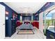 Baseball themed bedroom with red and blue color scheme and access to an enclosed patio at 926 Boundary Blvd, Rotonda West, FL 33947