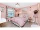 All pink bedroom with a modern chandelier, stylish decor, and natural light from the window at 926 Boundary Blvd, Rotonda West, FL 33947