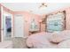 Charming bedroom with pink walls, stylish vanity, closet and natural light from the window at 926 Boundary Blvd, Rotonda West, FL 33947