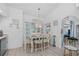 Bright dining area with white table, chairs, and beach themed window treatments, offering a cozy dining space at 926 Boundary Blvd, Rotonda West, FL 33947