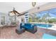 Beautiful lanai featuring comfortable seating, ceiling fan, and view of the inviting pool at 926 Boundary Blvd, Rotonda West, FL 33947