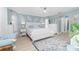 Serene main bedroom with soothing blue walls and ample natural light, creating a relaxing and inviting retreat at 926 Boundary Blvd, Rotonda West, FL 33947