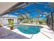 Screened-in private pool with clear blue water, brick patio and tropical plants, offering a relaxing outdoor oasis at 926 Boundary Blvd, Rotonda West, FL 33947
