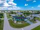 Aerial view of a charming turquoise home with lush landscaping, sitting pretty in a quiet neighborhood at 9457 Heartwellville Ave, Englewood, FL 34224
