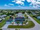Charming turquoise home with dark roof, green landscaping and a lovely quiet neighborhood at 9457 Heartwellville Ave, Englewood, FL 34224
