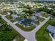 Beautiful aerial view of a turquoise home with green landscaping in a lovely residential neighborhood at 9457 Heartwellville Ave, Englewood, FL 34224