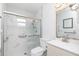 Updated bathroom featuring tiled shower, glass door, and modern fixtures at 9457 Heartwellville Ave, Englewood, FL 34224