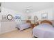 Cozy bedroom with two twin beds, ceiling fan, and decorative wallpaper border at 9457 Heartwellville Ave, Englewood, FL 34224