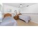 Bedroom featuring two twin beds, ceiling fan, and floral wallpaper accents at 9457 Heartwellville Ave, Englewood, FL 34224