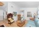 Inviting living room with wicker seating, bright walls, wood floors, and a decorative mirror at 9457 Heartwellville Ave, Englewood, FL 34224