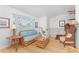 Comfortable living room features a wicker couch and chairs, wood floors, and large windows at 9457 Heartwellville Ave, Englewood, FL 34224