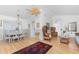 Bright living room with elegant furnishings, including wicker chairs, a ceiling fan and wood floors at 9457 Heartwellville Ave, Englewood, FL 34224