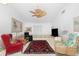 Cozy living room with a ceiling fan, tile floors, and lots of natural light at 9457 Heartwellville Ave, Englewood, FL 34224
