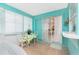 Sunroom with tile floors and turquoise walls connects to the house at 9457 Heartwellville Ave, Englewood, FL 34224