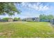 Spacious backyard with green grass, shed, full RV hookups, and privacy fence at 10263 Waterford Ave, Englewood, FL 34224