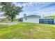 Backyard of home with a small patio, RV hookups, and privacy fence at 10263 Waterford Ave, Englewood, FL 34224