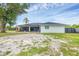 Rear of home with screened lanai and fenced-in yard at 10263 Waterford Ave, Englewood, FL 34224