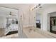 Bathroom vanity with a large mirror reflecting the bedroom and walk-in closet at 10263 Waterford Ave, Englewood, FL 34224