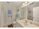 Clean bathroom featuring a vanity, toilet, and a shower with glass doors at 10263 Waterford Ave, Englewood, FL 34224