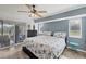 Bright bedroom featuring a starfish patterned comforter, wood-look floors, and a sliding glass door at 10263 Waterford Ave, Englewood, FL 34224