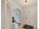 Inviting entryway featuring tile flooring, a closet, an arched doorway and a view into the living room at 10263 Waterford Ave, Englewood, FL 34224