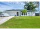 Attractive single-story home featuring a two-car garage and beautiful lawn at 10263 Waterford Ave, Englewood, FL 34224