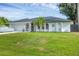 Beautiful single-story home featuring a well-maintained lawn, two-car garage, and architectural details at 10263 Waterford Ave, Englewood, FL 34224