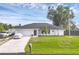 Charming single-story home featuring a two-car garage, green lawn, and well-maintained landscaping at 10263 Waterford Ave, Englewood, FL 34224