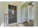 Welcoming front entrance with a decorative door, 'Hello' sign, and tiled porch at 10263 Waterford Ave, Englewood, FL 34224
