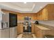 Bright kitchen with stainless steel appliances, granite countertops, and ample wood cabinets at 10263 Waterford Ave, Englewood, FL 34224