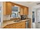 Bright updated kitchen has wood cabinets, granite countertops and stainless appliances at 10263 Waterford Ave, Englewood, FL 34224