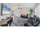 Cozy living room with comfortable seating, stylish rug, and a large TV at 10263 Waterford Ave, Englewood, FL 34224