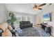 Bright living room featuring stylish furniture, a large area rug, and views of the front yard at 10263 Waterford Ave, Englewood, FL 34224