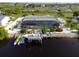 Waterfront property with a private dock, boat lift, screened lanai, and pool, perfect for boating enthusiasts at 1030 Haste Ln, Englewood, FL 34223
