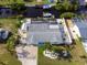 Aerial view of a home with screened pool, shed, dock, and canal access in a desirable location at 1030 Haste Ln, Englewood, FL 34223