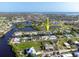 Aerial view of a waterfront community with canals and lush landscaping at 1030 Haste Ln, Englewood, FL 34223