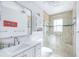 Modern bathroom with glass enclosed shower, tiled walls and updated fixtures at 1030 Haste Ln, Englewood, FL 34223