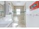 Modern bathroom with glass enclosed shower, tiled walls and updated fixtures at 1030 Haste Ln, Englewood, FL 34223