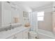 Modern bathroom with walk-in shower, tiled walls and updated fixtures at 1030 Haste Ln, Englewood, FL 34223