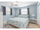Calming bedroom with blue walls, seashell bedding, and ample natural light at 1030 Haste Ln, Englewood, FL 34223
