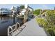 Dock showcasing a boat lift and canal access, complimented by lush greenery at 1030 Haste Ln, Englewood, FL 34223