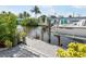 Waterfront dock featuring a boat lift and canal access with lush landscaping at 1030 Haste Ln, Englewood, FL 34223