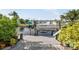 Wooden dock with boat lift, canal access, and mature landscaping at 1030 Haste Ln, Englewood, FL 34223