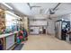 Spacious garage with storage solutions, a work bench, a washer, and a dryer, offering functional space at 1030 Haste Ln, Englewood, FL 34223