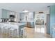 Bright kitchen featuring an island with bar stool seating, stainless appliances, and an open layout at 1030 Haste Ln, Englewood, FL 34223