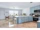 Spacious kitchen featuring stainless steel appliances, an island with bar seating, and marble countertops at 1030 Haste Ln, Englewood, FL 34223