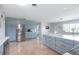 Open kitchen with sleek countertops, stainless steel appliances, and blue cabinets at 1030 Haste Ln, Englewood, FL 34223