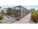 Enclosed lanai with dining and lounge areas is perfect for entertaining and enjoying the beautiful outdoor space at 1030 Haste Ln, Englewood, FL 34223