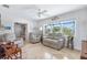 Cozy living room with neutral furniture, large window, and open layout at 1030 Haste Ln, Englewood, FL 34223